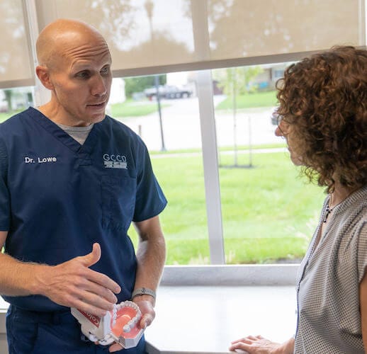 dentist explaining to patient about emergency